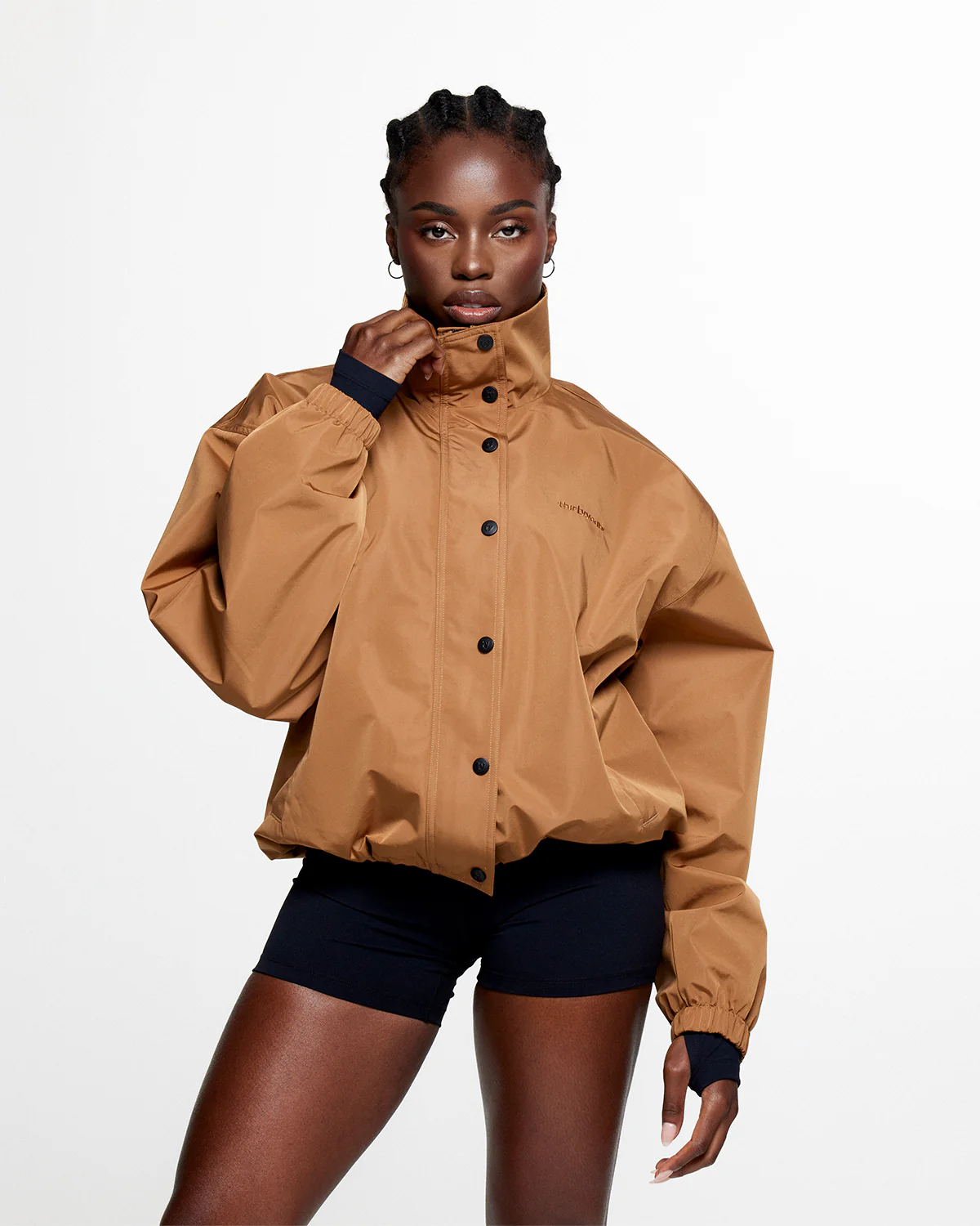 A woman wearing a camel brown classic jacket