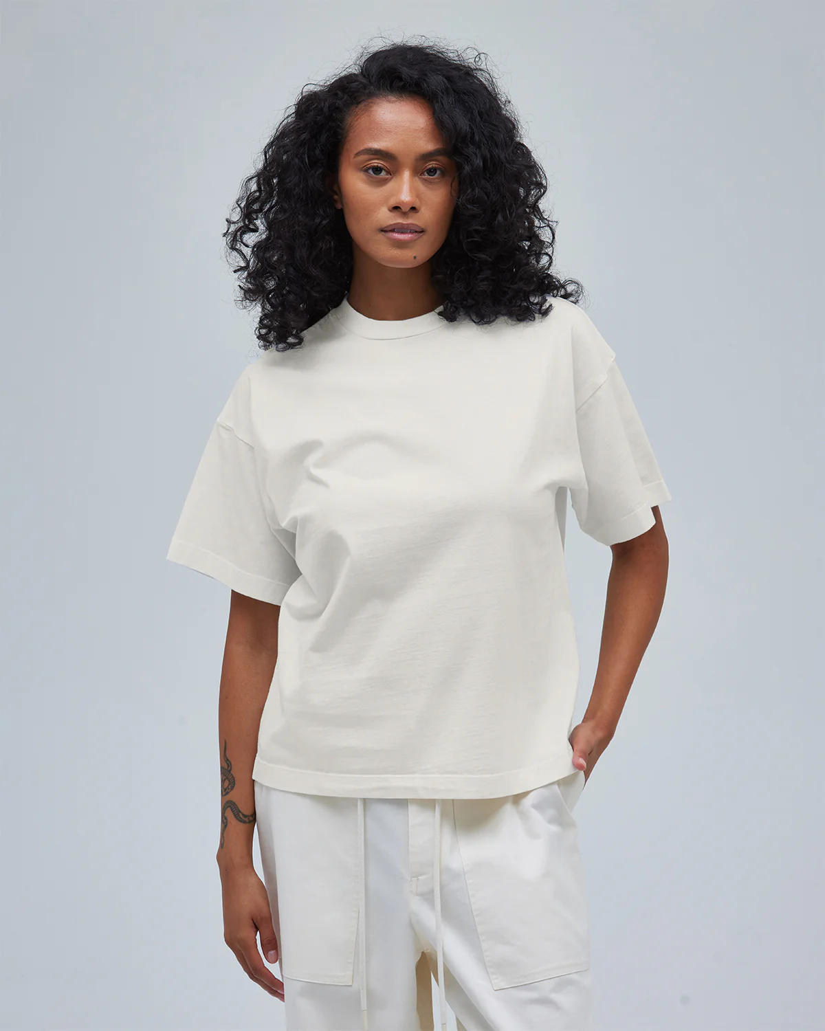 A model wearing women's boxy tee and pants in cream