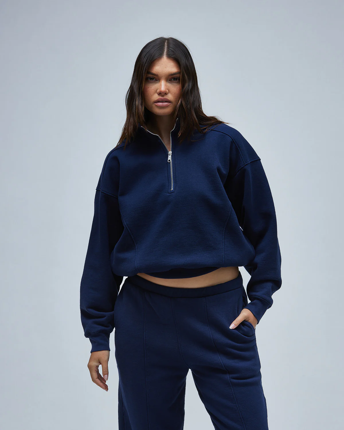 A woman wearing a cozy sweatshirt in blue