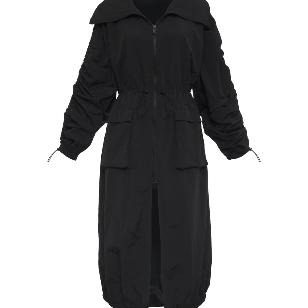 black mid-length nylon trench jacket. fold over collar, two-way zip closure, bungee cinch at the waist, hem, two front pockets, two side seam pockets.