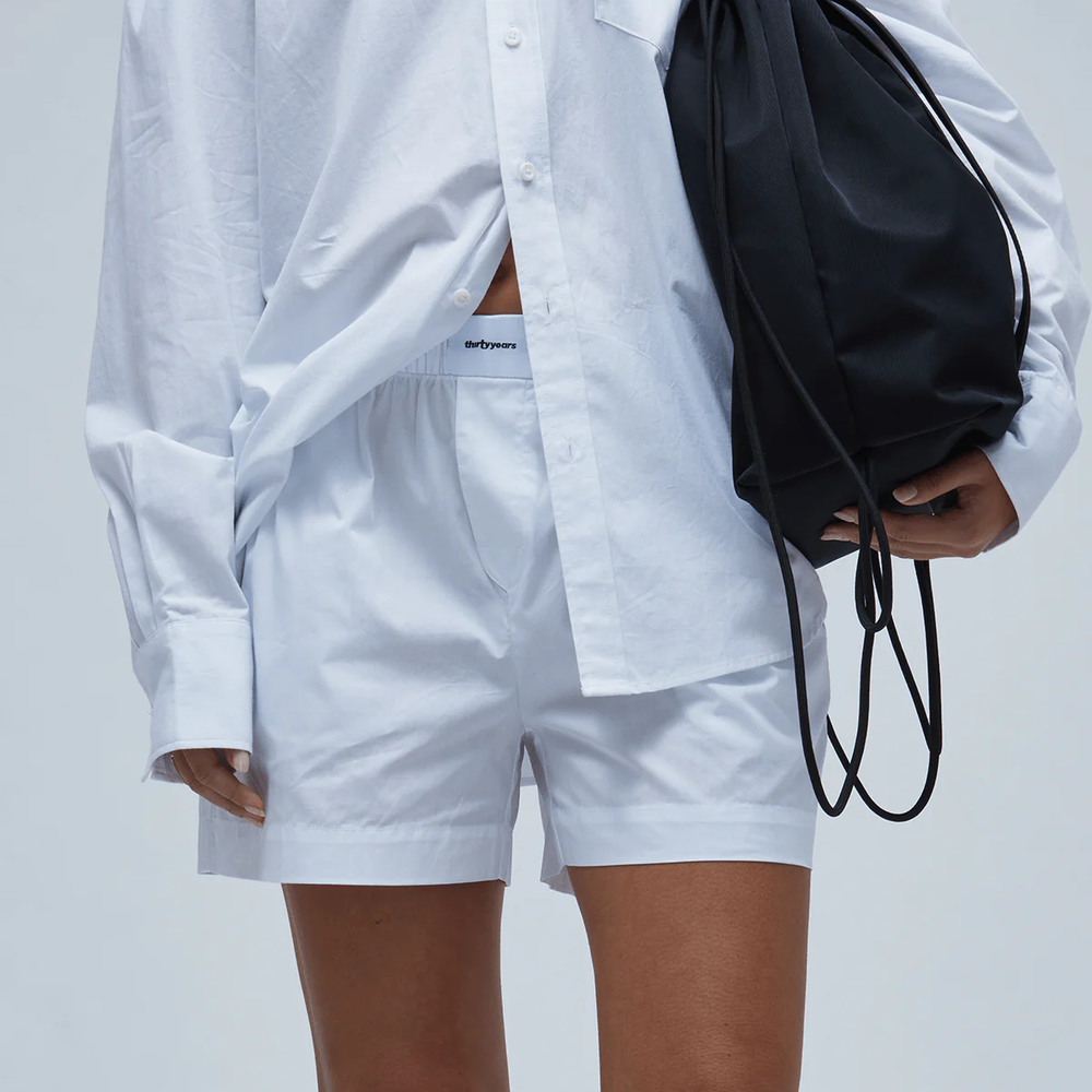 Woman holding a black drawstring purse