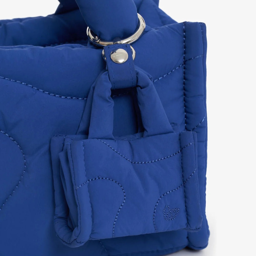 A blue bag charm on a blue bag
