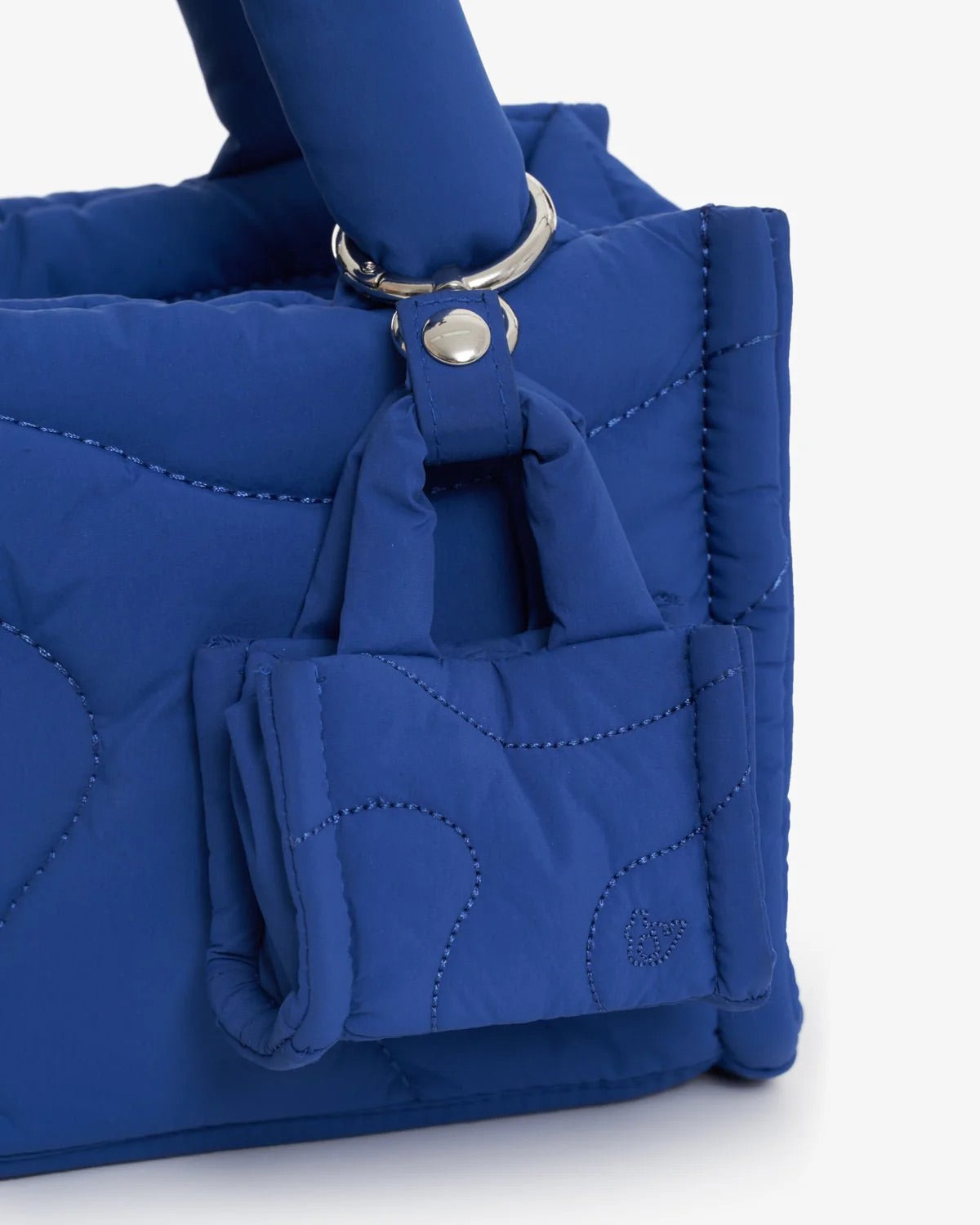 A blue bag charm on a blue bag