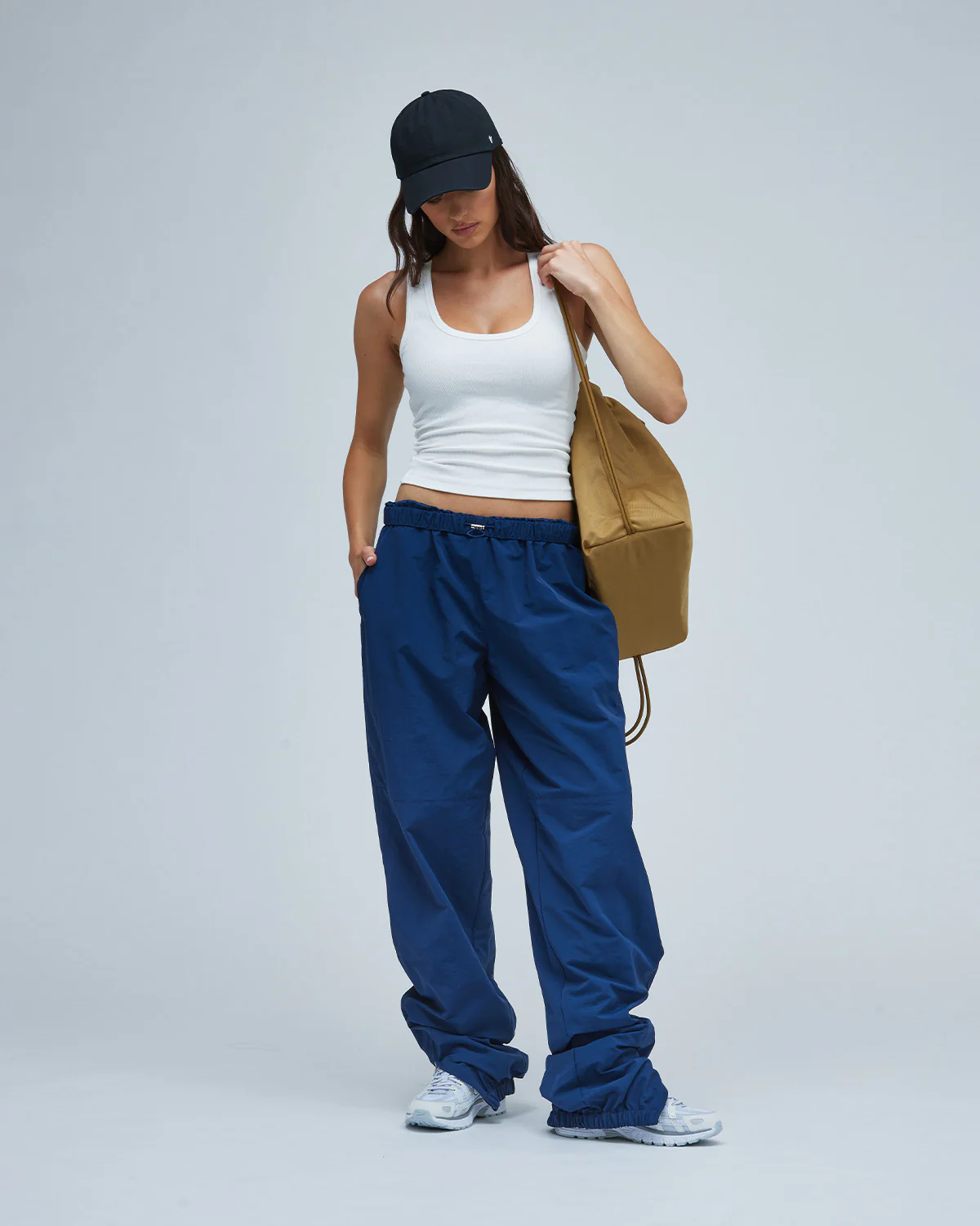 Woman wearing a white tank top and blue women's casual bottoms